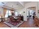 Bright dining room with a chandelier, wood floors, and views into other living areas at 8404 White Poplar Dr, Riverview, FL 33578