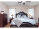 Inviting main bedroom featuring wood floors, ceiling fan, and lots of light at 8404 White Poplar Dr, Riverview, FL 33578