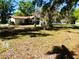 Spacious backyard with mature trees, offering a private and serene outdoor space at 908 N Knight St, Plant City, FL 33563