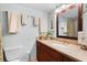 Bathroom featuring a vanity with granite countertop and decorative mirror at 9433 Harbor Greens Way # 401, Seminole, FL 33776