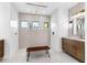 Luxurious bathroom featuring patterned tile accent wall, walk-in shower with bench, and double sink vanity at 9514 Snapper Cir, Port Charlotte, FL 33981