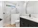 Modern bathroom featuring marble-look tile shower, toilet, vanity with marble-look top, and sleek fixtures at 9514 Snapper Cir, Port Charlotte, FL 33981