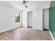 Bright bedroom featuring wood-look flooring, a closet, and natural light from a large window at 9514 Snapper Cir, Port Charlotte, FL 33981