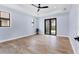 A spacious bedroom features tray ceilings, recessed lighting, and french doors leading to the outdoors at 9514 Snapper Cir, Port Charlotte, FL 33981