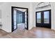 Elegant foyer with wood-look flooring and a view of a study through glass-paned double doors at 9514 Snapper Cir, Port Charlotte, FL 33981