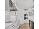 Modern kitchen features white cabinets, stainless steel appliances, and a stylish range hood at 9514 Snapper Cir, Port Charlotte, FL 33981
