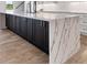 Kitchen island features beautiful marble countertop and dark cabinets with bronze hardware at 9514 Snapper Cir, Port Charlotte, FL 33981