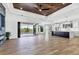 Spacious open floor plan with hardwood floors and access to the pool at 9514 Snapper Cir, Port Charlotte, FL 33981