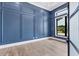 Modern office features blue accent wall and hardwood floors at 9514 Snapper Cir, Port Charlotte, FL 33981