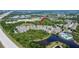 Aerial view of the apartment complex with a pond, pool, surrounding foliage, and proximity to a highway at 9526 Newdale Way # 101, Riverview, FL 33578