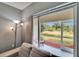 Living room view of outdoor balcony space overlooking a lush green landscape at 9526 Newdale Way # 101, Riverview, FL 33578