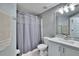 Bathroom featuring a shower/tub with gray tile shower curtain, and white vanity at 9526 Newdale Way # 101, Riverview, FL 33578
