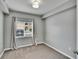 Cozy bedroom featuring a window with stylish curtains and plush gray carpeting at 9526 Newdale Way # 101, Riverview, FL 33578