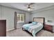 Cozy bedroom with a ceiling fan, window, and neutral decor at 9526 Newdale Way # 101, Riverview, FL 33578