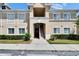 Charming condo with a well-manicured front yard, stairs leading to the entry, and an appealing facade at 9526 Newdale Way # 101, Riverview, FL 33578