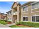Inviting condo with landscaped grounds, featuring covered entry and a well-maintained facade at 9526 Newdale Way # 101, Riverview, FL 33578