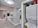 Cozy interior view with a breakfast bar, adjacent laundry closet, and open access to the kitchen at 9526 Newdale Way # 101, Riverview, FL 33578