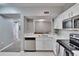 Modern kitchen with white cabinets, stainless steel appliances, and an open layout at 9526 Newdale Way # 101, Riverview, FL 33578