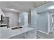 Bright kitchen featuring quartz counters with bar seating, stainless steel faucet, and a tiled backsplash at 9526 Newdale Way # 101, Riverview, FL 33578