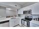 Updated kitchen featuring stainless steel appliances, white cabinets, and modern countertops at 9526 Newdale Way # 101, Riverview, FL 33578