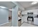 Bright kitchen with stainless steel appliances, white cabinetry, and a tiled backsplash at 9526 Newdale Way # 101, Riverview, FL 33578