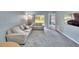 Spacious living room with plush gray carpeting, comfortable seating, and large windows at 9526 Newdale Way # 101, Riverview, FL 33578