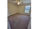Carpeted bedroom with neutral walls, a ceiling fan, and a bright window at 10200 Gandy N Blvd # 235, St Petersburg, FL 33702