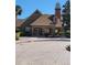 Community clubhouse exterior with brick facade and distinctive lighthouse feature at 10200 Gandy N Blvd # 235, St Petersburg, FL 33702