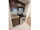 Compact kitchen features dark wood cabinetry, stainless steel oven, and granite countertops at 10200 Gandy N Blvd # 235, St Petersburg, FL 33702