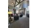 Inviting living area with high ceilings, cozy seating, and a stone fireplace at 10200 Gandy N Blvd # 235, St Petersburg, FL 33702
