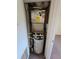 Compact utility closet featuring water heater and HVAC system at 10200 Gandy N Blvd # 235, St Petersburg, FL 33702