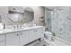 Modern bathroom boasts a double vanity and an updated walk-in shower with marble tile at 1120 E Kennedy Blvd # 411, Tampa, FL 33602