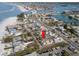 Aerial view of the property location denoted by a red arrow, near beach at 12404 Sunshine Ln, Treasure Island, FL 33706