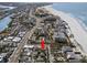 Aerial view of property near the beach, denoted by a red arrow at 12404 Sunshine Ln, Treasure Island, FL 33706