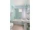 Bathroom featuring turquoise tile and white fixtures at 12404 Sunshine Ln, Treasure Island, FL 33706