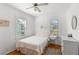 Bedroom featuring white wood paneling, wood floors, and a comfortable bed at 12404 Sunshine Ln, Treasure Island, FL 33706