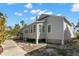 This home features a sunroom, a chimney, and sits on posts at 12404 Sunshine Ln, Treasure Island, FL 33706