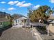 Charming single-story home with a inviting covered porch and a carport at 12404 Sunshine Ln, Treasure Island, FL 33706