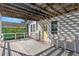 Inviting covered porch featuring outdoor seating, and a charming yellow front door at 12404 Sunshine Ln, Treasure Island, FL 33706