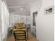 Bright sunroom with large windows, ceiling fans, and comfortable seating at 12404 Sunshine Ln, Treasure Island, FL 33706