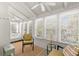 Bright sunroom with large windows, ceiling fans, and comfortable seating at 12404 Sunshine Ln, Treasure Island, FL 33706