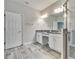 Bright bathroom featuring a double vanity, granite countertop, and a glass-enclosed shower at 12427 Bay Estuary Bnd, Riverview, FL 33579