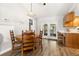 Bright dining area featuring a wooden table, chairs, hardwood floors, and access to the backyard at 14 Cypress Dr, Palm Harbor, FL 34684