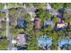 An aerial view showcasing a well-situated home on a neatly lined street with a generous amount of trees and greenery at 1439 Wetherington Way, Palm Harbor, FL 34683