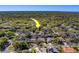 An aerial image displaying the home's location within a mature, lush neighborhood and easy access to city amenities at 1439 Wetherington Way, Palm Harbor, FL 34683