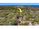 The aerial shows the home's great access to nearby amenities with its fantastic location in a lush, tree-filled neighborhood at 1439 Wetherington Way, Palm Harbor, FL 34683