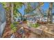 Inviting backyard patio with outdoor seating surrounded by lush landscaping at 1439 Wetherington Way, Palm Harbor, FL 34683