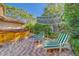 Charming backyard with hot tub, lounge chairs, and a shaded umbrella, perfect for outdoor relaxation at 1439 Wetherington Way, Palm Harbor, FL 34683