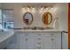Bright bathroom featuring double sinks, a granite countertop, and plenty of storage at 1439 Wetherington Way, Palm Harbor, FL 34683