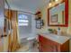 Bright bathroom featuring a vanity, toilet, and shower with a curtain, perfect for everyday use at 1439 Wetherington Way, Palm Harbor, FL 34683